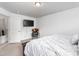 Inviting bedroom featuring a queen-size bed, TV, and comfortable accent chair at 1009 Haynoke Dr, Graham, NC 27253