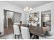 Elegant dining room featuring modern lighting, stylish decor, and seamless access to the living area and kitchen at 1009 Haynoke Dr, Graham, NC 27253