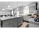 Stylish kitchen with gray cabinetry, a granite island with seating, and an open layout to the living area at 1009 Haynoke Dr, Graham, NC 27253