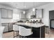 Modern kitchen featuring gray cabinets, stainless steel appliances, granite countertops, and a central island at 1009 Haynoke Dr, Graham, NC 27253