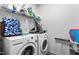 Functional laundry room with washer, dryer, and ample storage shelves at 1009 Haynoke Dr, Graham, NC 27253