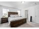 Spacious main bedroom with a wooden bed frame and ensuite bathroom access at 1009 Haynoke Dr, Graham, NC 27253