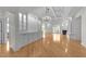 Bright and airy living room features hardwood floors, custom built-ins, and a crystal chandelier at 10410 Rosegate Ct # 307, Raleigh, NC 27617