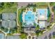 Aerial shot of a community pool and tennis courts, surrounded by lush greenery at 10410 Rosegate Ct, Raleigh, NC 27617