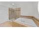 Modern bathroom featuring glass enclosed shower and soaking tub at 10410 Rosegate Ct, Raleigh, NC 27617