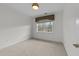 Bright, empty bedroom featuring carpeted floors and a window at 10410 Rosegate Ct, Raleigh, NC 27617