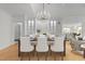 Dining room with wood floors, chandelier, and built-in cabinets at 10410 Rosegate Ct, Raleigh, NC 27617