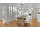 Bright dining room features a modern chandelier, coffered ceiling, and built-in cabinetry at 10410 Rosegate Ct, Raleigh, NC 27617
