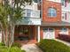 Inviting entrance showcasing brick accents, a charming balcony, and well-manicured landscaping at 10410 Rosegate Ct, Raleigh, NC 27617