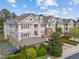 Beautiful townhome exterior with a blend of siding and brick, complemented by lush greenery at 10410 Rosegate Ct, Raleigh, NC 27617