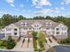 A charming exterior view of a townhome complex with private garages and lush landscaping at 10410 Rosegate Ct, Raleigh, NC 27617