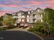 Charming exterior shot of a tan and brick condo building showcasing well-maintained landscaping and a tranquil setting at 10410 Rosegate Ct, Raleigh, NC 27617