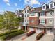 Inviting townhome with brick and siding exterior, attached garages, and manicured landscaping at 10410 Rosegate Ct, Raleigh, NC 27617