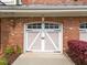 Close-up of the garage door featuring white trim and a decorative design, adding to the curb appeal at 10410 Rosegate Ct, Raleigh, NC 27617