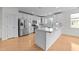 Modern kitchen with stainless steel appliances, white cabinetry, and marble countertops at 10410 Rosegate Ct, Raleigh, NC 27617