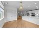 Bright, open kitchen with stainless steel appliances, pendant lighting, and hardwood floors at 10410 Rosegate Ct, Raleigh, NC 27617