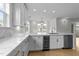 Kitchen with stainless steel appliances, marble counters, wine cooler, and hardwood floors at 10410 Rosegate Ct, Raleigh, NC 27617