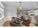 A cozy kitchen nook featuring a round table with four chairs and modern light fixture at 10410 Rosegate Ct, Raleigh, NC 27617