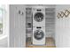 A well-organized laundry room features a stacked washer/dryer and ample shelving at 10410 Rosegate Ct, Raleigh, NC 27617
