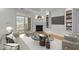 Bright living room with fireplace, built-in cabinets, large windows, and modern furnishings at 10410 Rosegate Ct, Raleigh, NC 27617