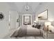 Spacious main bedroom with tray ceiling, chandelier, and sitting area at 10410 Rosegate Ct, Raleigh, NC 27617