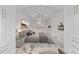 Luxurious main bedroom featuring a tray ceiling, chandelier, and built-in wardrobes at 10410 Rosegate Ct, Raleigh, NC 27617