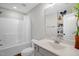 Bright bathroom featuring a combination tub and shower, toilet, and sink with vanity at 109 E Fayetteville St, Micro, NC 27555