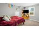Bedroom with a cozy bed, TV on wooden stand and a window at 109 E Fayetteville St, Micro, NC 27555
