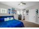 Bedroom with blue bedding, ceiling fan, and view of the en-suite bathroom at 109 E Fayetteville St, Micro, NC 27555