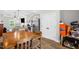 Dining area with an adjacent kitchen, wood floors, and natural light at 109 E Fayetteville St, Micro, NC 27555