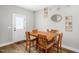 Dining area featuring wooden table and chairs with wood-look flooring at 109 E Fayetteville St, Micro, NC 27555