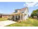 Exterior side view of cozy home with a well manicured lawn at 109 E Fayetteville St, Micro, NC 27555