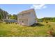 Exterior view of a two story home showcasing a grassy yard and light gray vinyl siding at 109 E Fayetteville St, Micro, NC 27555