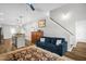 Living area featuring a comfortable blue sofa and wooden floors at 109 E Fayetteville St, Micro, NC 27555