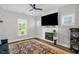 Stylish living room featuring fireplace and large TV at 109 E Fayetteville St, Micro, NC 27555