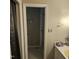 Bathroom doorway that reveals a tiled walk-in shower and a vanity with neutral countertop at 1102 Parkwood Dr, Siler City, NC 27344