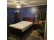 Bedroom with dark blue walls, carpet, a full-sized bed, and a side table at 1102 Parkwood Dr, Siler City, NC 27344