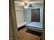 Bright bedroom with two twin beds, a ceiling fan, and neutral carpet at 1102 Parkwood Dr, Siler City, NC 27344