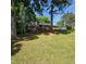 Exterior shot of a two-story home with a lush front lawn and mature trees surrounding the property at 1102 Parkwood Dr, Siler City, NC 27344
