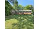 Charming brick home with green shutters and a well-maintained lawn at 1102 Parkwood Dr, Siler City, NC 27344