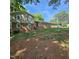 Home with brick and siding and a sloped front yard and well-maintained landscaping at 1102 Parkwood Dr, Siler City, NC 27344