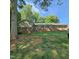 Charming brick home with a sprawling front yard, complemented by lush greenery and mature trees at 1102 Parkwood Dr, Siler City, NC 27344