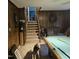 Game room with a pool table, comfortable seating, and a staircase leading to another level at 1102 Parkwood Dr, Siler City, NC 27344