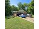 Home with a two-car garage and uniquely painted car parked in the driveway at 1102 Parkwood Dr, Siler City, NC 27344