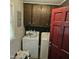 Laundry room equipped with washer, dryer, storage cabinets, and a window for natural light at 1102 Parkwood Dr, Siler City, NC 27344