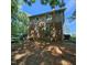 Home featuring brick and siding with a yard storing equipment and a wooded area nearby at 1102 Parkwood Dr, Siler City, NC 27344
