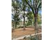 Large backyard with mature trees, fallen leaves, and partial fencing at 112 Hilton Ave, Durham, NC 27707