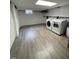 Finished basement with a laundry area including a washer and dryer, as well as new vinyl flooring at 112 Hilton Ave, Durham, NC 27707