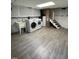 The finished basement has modern vinyl floors, a laundry area with appliances, and exposed brick stairs at 112 Hilton Ave, Durham, NC 27707