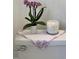 Charming bathroom decor with orchid and candle on the toilet at 112 Hilton Ave, Durham, NC 27707